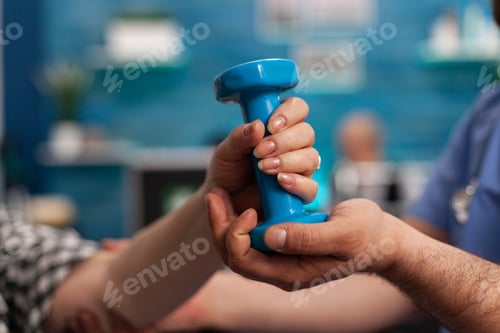 Preview: Close up of old woman hand using dumbbel to recover and rehabilitate