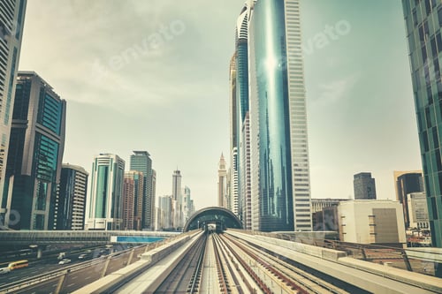 Preview: Retro toned photo of Dubai modern downtown seen from metro train