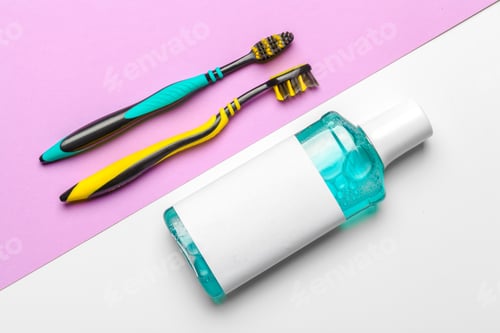 Preview: Flat lay composition with manual toothbrushes and oral hygiene product