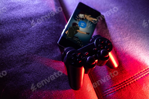 Preview: Gamer work space concept. gaming set up. top view of a gaming gear, joystick and a smartphone