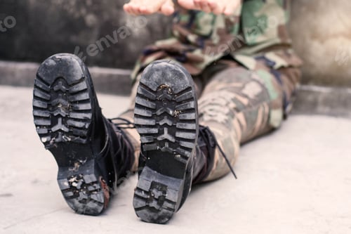 Fatigued Soldier Boots and Camo in Urban Setting
