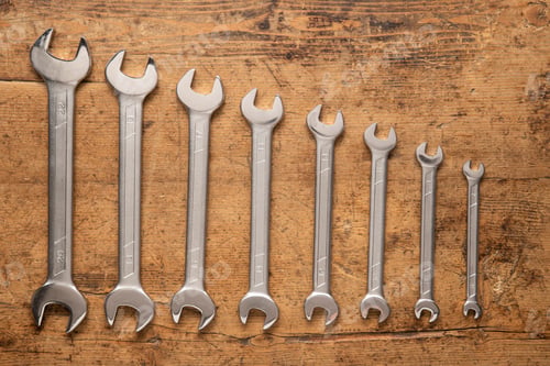 Preview: Wrenches of Varying Sizes on a Wooden Surface