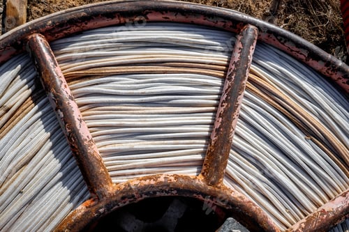 Preview: Rusty coil of white rope for construction.