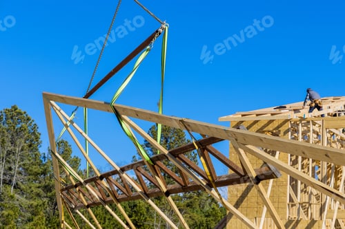 Preview: Wooden roof with crane holds a roof truss beams