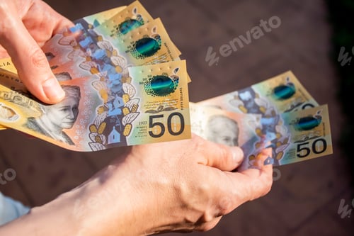 Preview: Hands holding australian dollars 50 banknotes. Finance and payment concept