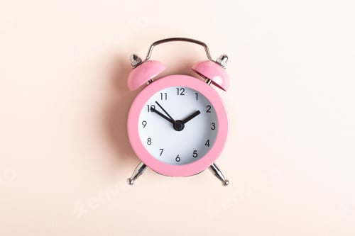 Preview: Pink alarm clock on a pink background