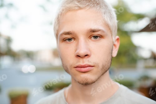 Preview: Close-up portrait of young blond man outdoor