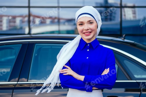 Preview: Arab business woman hijab standing in front of her luxury car on the street