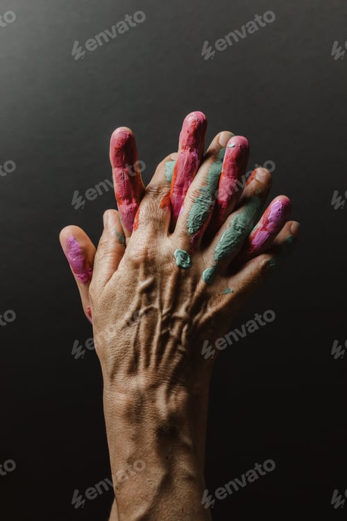 Preview: Fun leisure. Creative female artist showing hands dirty with different colors paint