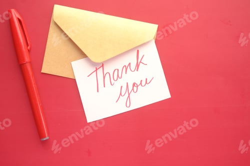 Preview: thank you message and envelope on wooden table