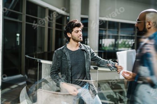 Preview: Confident employee discussing startup with partner