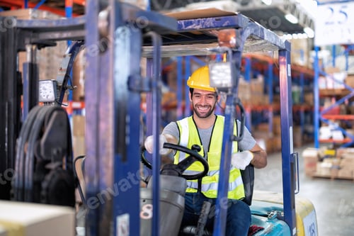 Preview: Forklift Truck Operator Lifts Pallet Cardboard Boxes On a Shelf by Trucks smiling portrait
