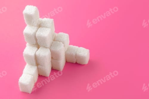 Preview: Cubes of sugar on a pink background. Empty space for copying text