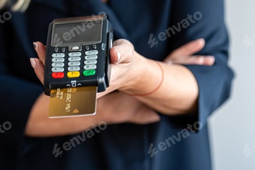 Preview: close-up of women hands hold terminal for payment by non-cash money