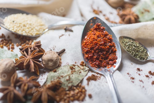 Preview: mix of different spices and herbs on a table with decor