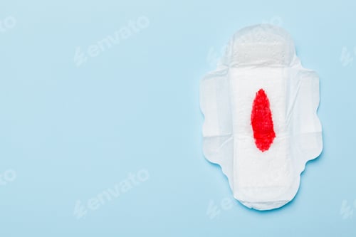 Preview: Women hygiene products or Sanitary pad with red feather on colored background.
