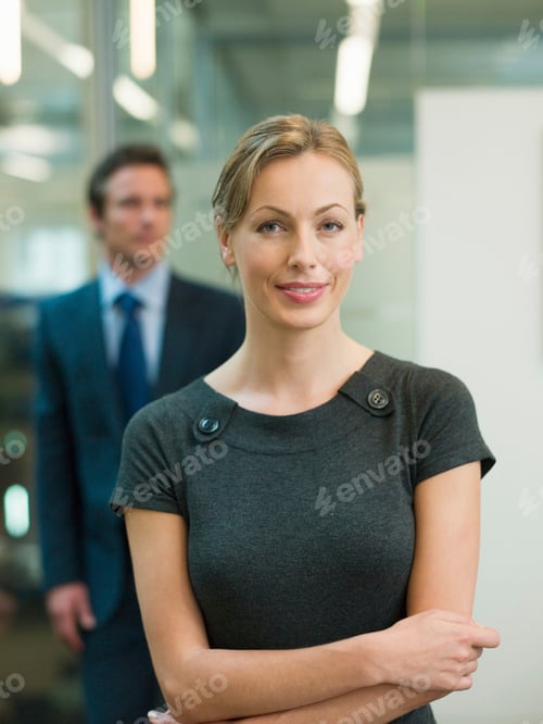 Preview: Confident professional woman at the forefront with a colleague in the background