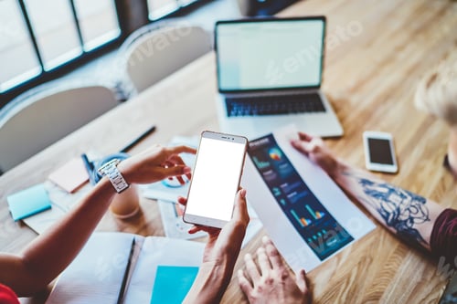 Preview: Colleagues surfing cellphone and checking graph
