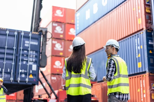 Preview: Caucasian business man and woman worker working in container terminal.