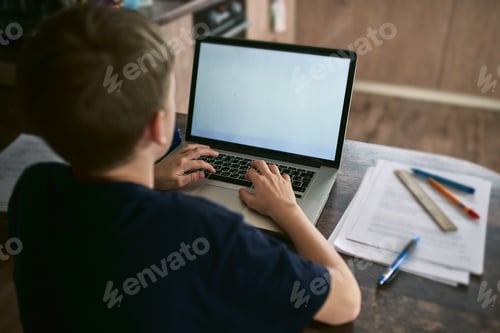 Preview: The concept of working from home and home family education. A boy is sitting at his desk