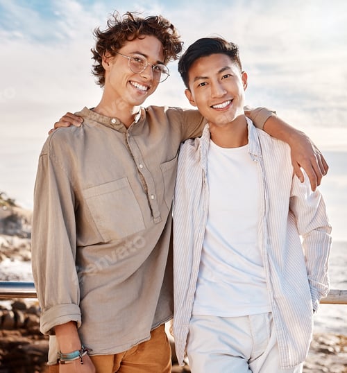 Preview: Portrait of two attractive young men standing together on the beach. Asian male and his best friend