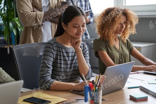 Preview: Businesswomen writing graphs and charts for statements