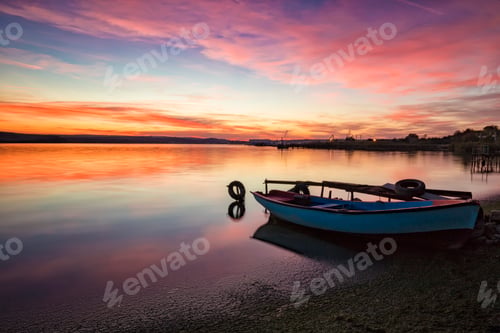 Preview: Colorful Sky at Sunrise with Boat on Shore
