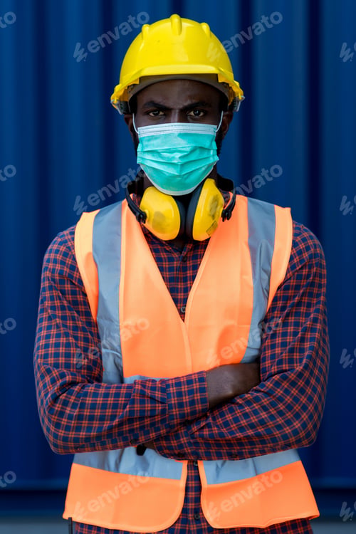 Preview: Man with protective mask before work. Man putting on medical face mask.