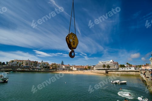 Preview: Hook of a crane hanging over the water on the shore