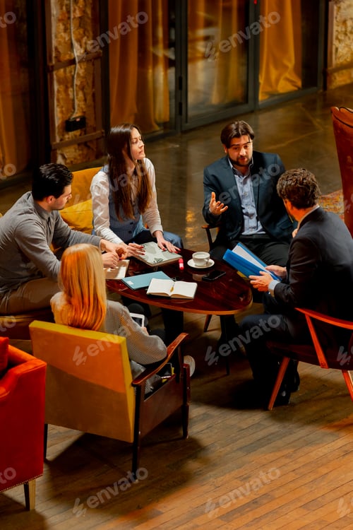 Preview: top shot in large beautiful hall office employees sitting on yellow chairs discuss a deal