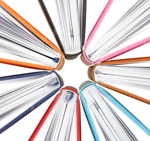 Preview: Top view of colorful books in a circle on white background