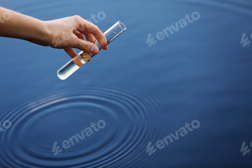 Preview: Water sample. Hand collects water to explore. Concept - water purity analysis, environment, ecology