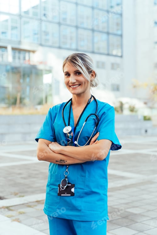 Preview: Smiling Woman Wearing Scrubs with Arms Crossed