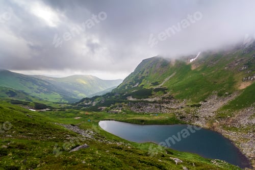 Preview: Fantastic wide peaceful view of blue lake in green valley