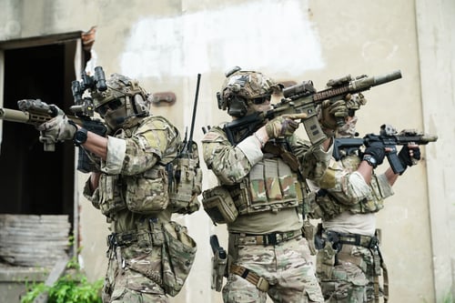 Preview: Soldier in full US MARSOC armed with assault rifle run through the abandoned building. Military