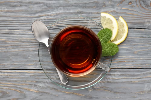 Preview: Concept of hot drink with tea on gray wooden background