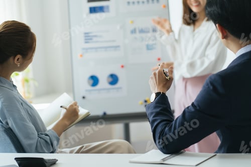 Preview: Three colleagues are concentrated on data at the flipchart, disscussing the solutions of their comp