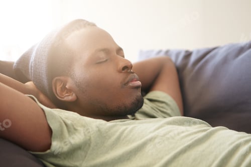 Preview: Sleeping handsome black man with full lips wearing black hat and green T-shirt having good dreames b