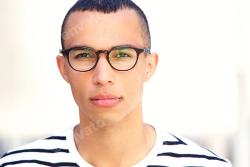 Preview: Close up front portrait of young man with glasses