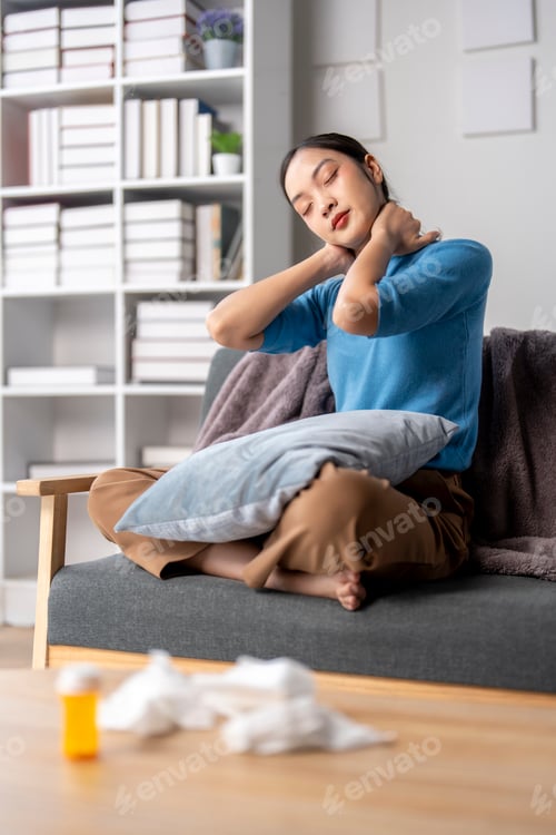 Preview: A woman is sitting on a couch with a pillow behind her back
