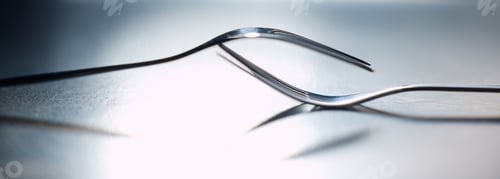 Preview: Two forks balanced one on another symbolizing togetherness, dependency and unity. A symbol of teamw