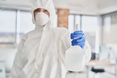 Preview: Technician holding a spray disinfectant in front of the camera