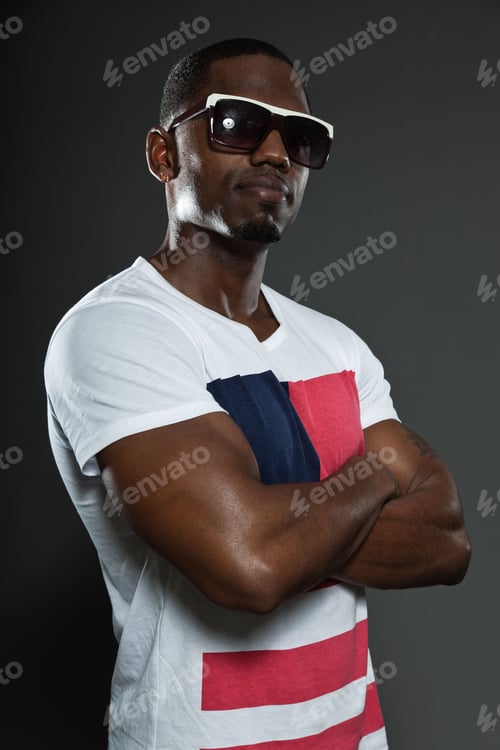 Preview: Cool Urban Stylish Black American Man. Fashion Studio Portrait Isolated On Grey Background. Wearing