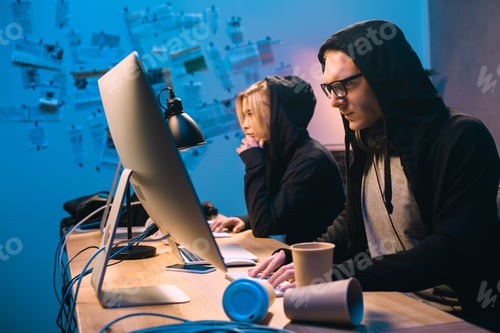 Preview: serious couple of hackers working with computers to develop new malware
