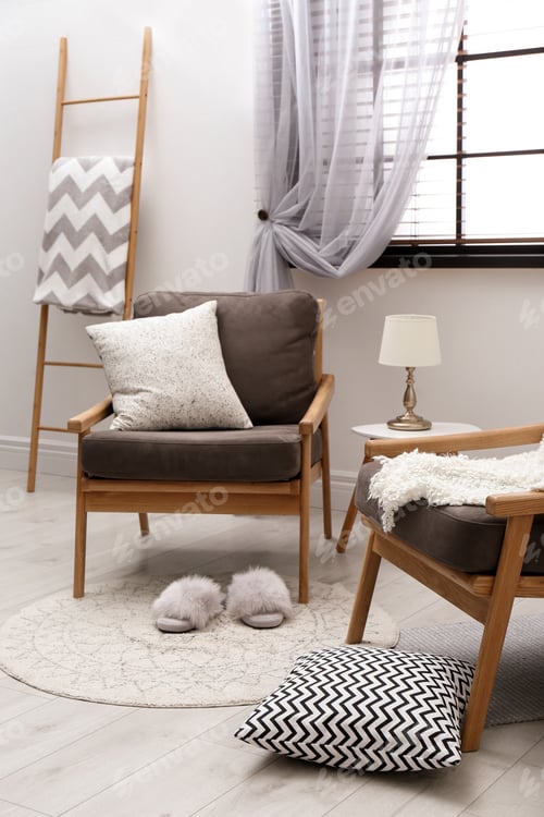 Preview: Cozy interior with armchairs, pillows and plaid near window
