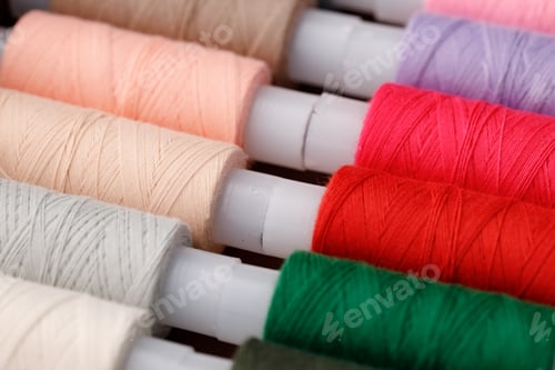 Preview: Close up of colored thread coils, thread spools background