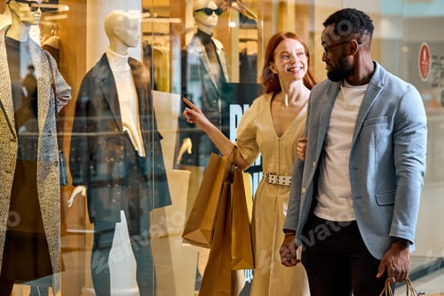 Preview: elegant happy diverse couple takes pleasure in window shopping