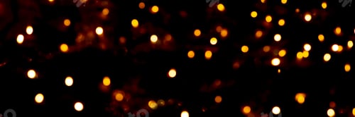 Preview: Blurry garland lights on a dark background. Festive Christmas and New Year background. Soft focus