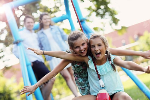 Preview: Joyful family having fun on playground