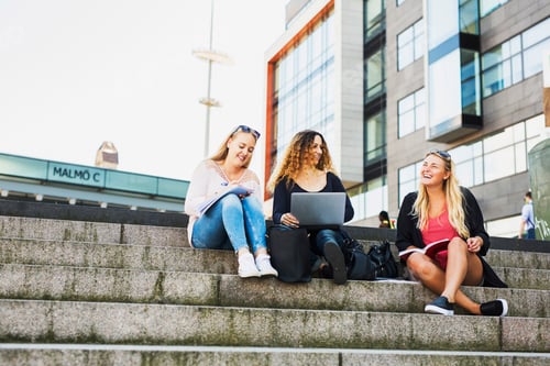 Preview: Three young women with laptop, sitting on steps